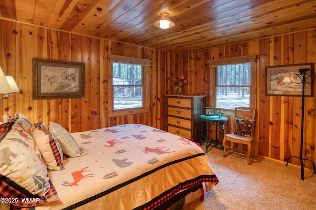 carpeted bedroom with wooden walls and wood ceiling