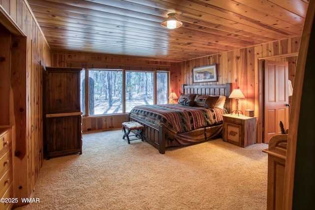 carpeted bedroom featuring wood ceiling and wooden walls