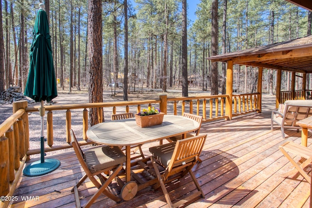 wooden terrace featuring outdoor dining area