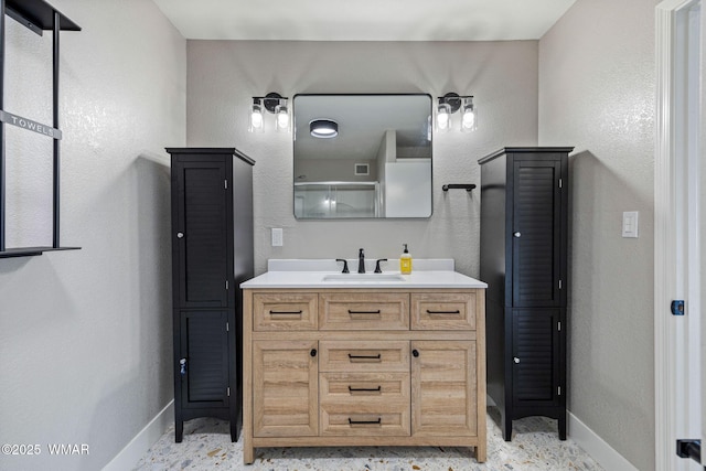 full bathroom featuring baseboards, vanity, a shower, and visible vents