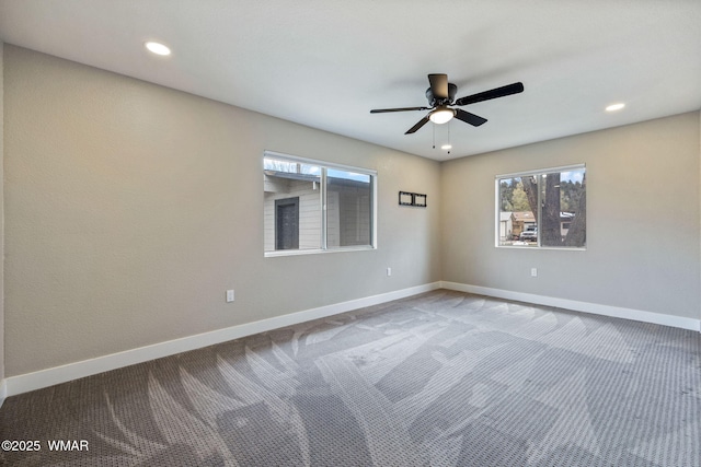 spare room featuring baseboards, a healthy amount of sunlight, and carpet