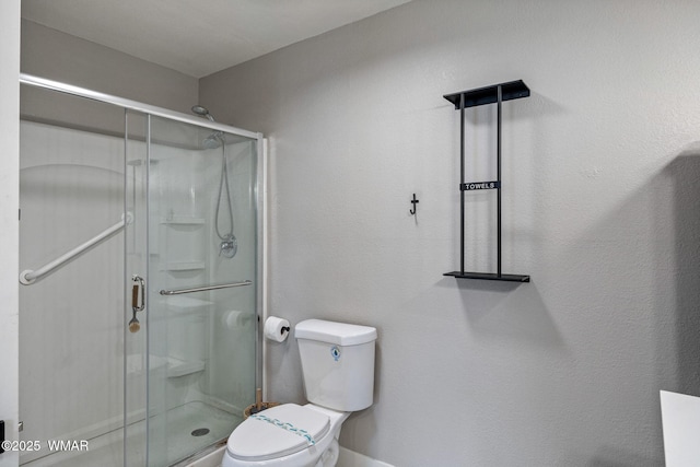 full bath with toilet and a stall shower