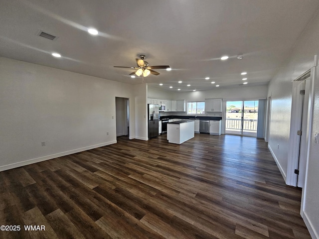 759 S 5th St W, Snowflake, AZ 85937 - unfurnished living room with recessed lighting, baseboards, a ceiling fan, and dark wood-type flooring