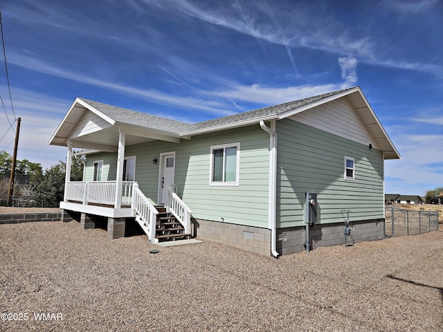 view of front of property with a porch, crawl space, fence, and roof with shingles