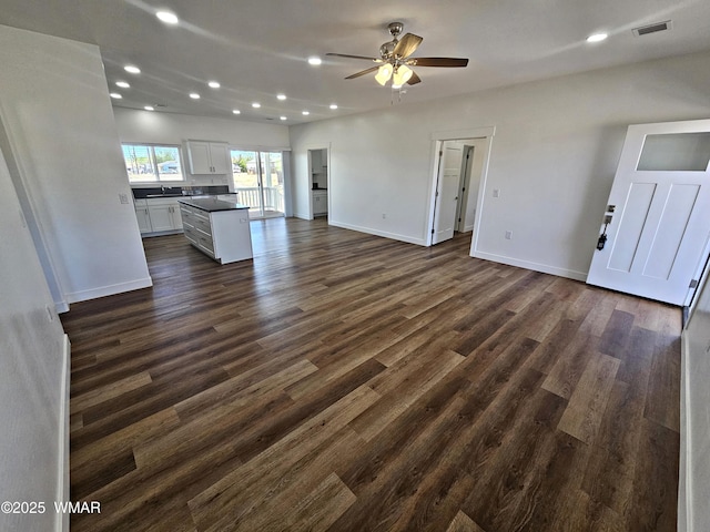 759 S 5th St W, Snowflake, AZ 85937 - unfurnished living room with ceiling fan, recessed lighting, dark wood-type flooring, baseboards, and a sink