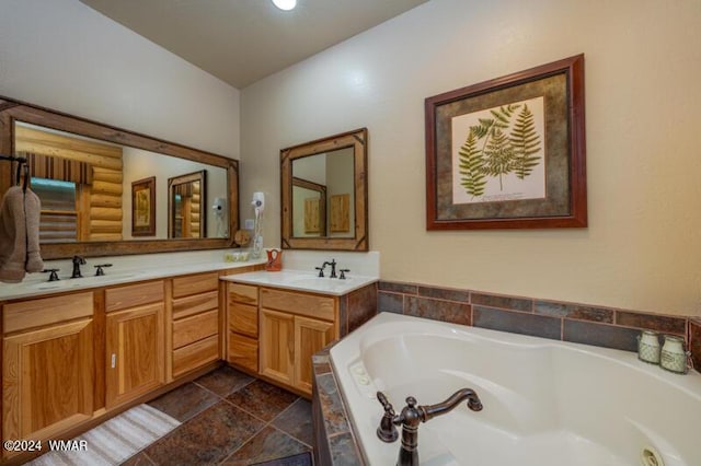 bathroom with a bath, a sink, and double vanity