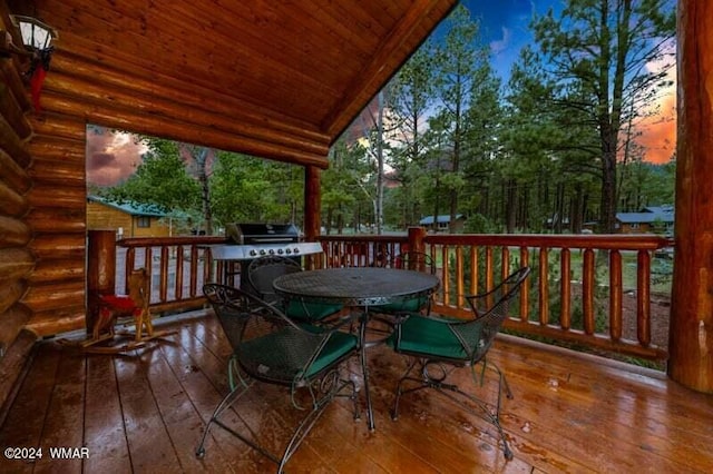 wooden terrace with outdoor dining space