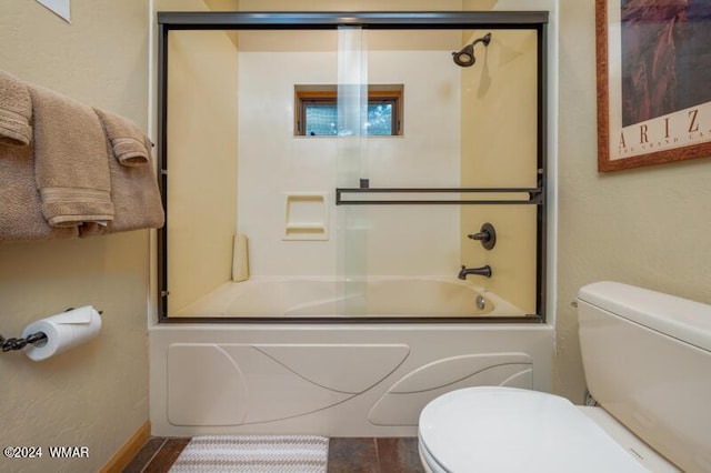 bathroom with combined bath / shower with glass door, wood finished floors, and toilet