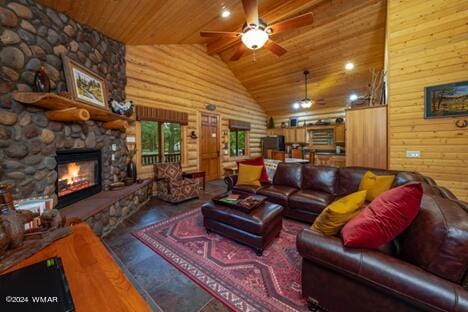 living room with wood ceiling, a ceiling fan, a fireplace, and high vaulted ceiling
