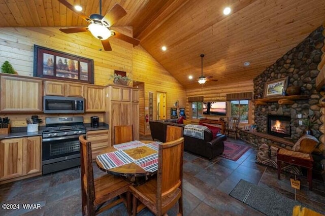 kitchen featuring stainless steel appliances, dark countertops, ceiling fan, wooden ceiling, and high vaulted ceiling