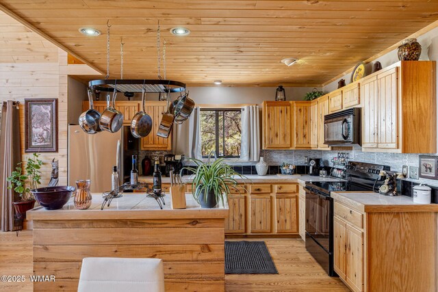 2796 Chandelle Ln, Overgaard, AZ 85933 - kitchen featuring black appliances, wood ceiling, tile countertops, light wood-style flooring, and tasteful backsplash