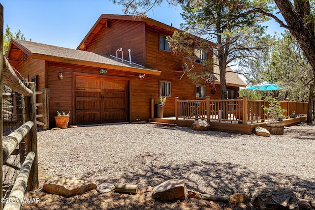 2796 Chandelle Ln, Overgaard, AZ 85933 - view of front facade with a garage, roof with shingles, driveway, and a deck