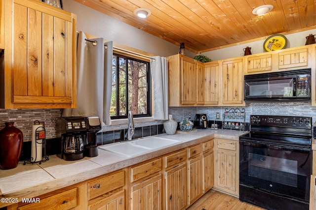 2796 Chandelle Ln, Overgaard, AZ 85933 - kitchen with black appliances, wood ceiling, decorative backsplash, tile countertops, and light wood-type flooring