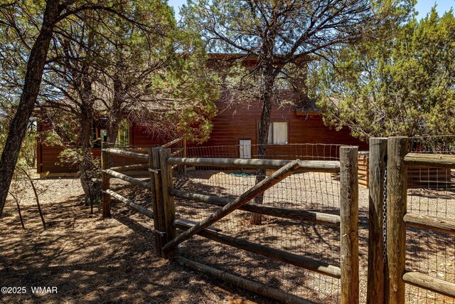 2796 Chandelle Ln, Overgaard, AZ 85933 - gate featuring an outbuilding and a barn