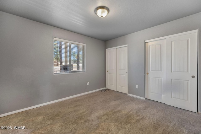 20 N Fox, Show Low, AZ 85901 - unfurnished bedroom featuring two closets and carpet