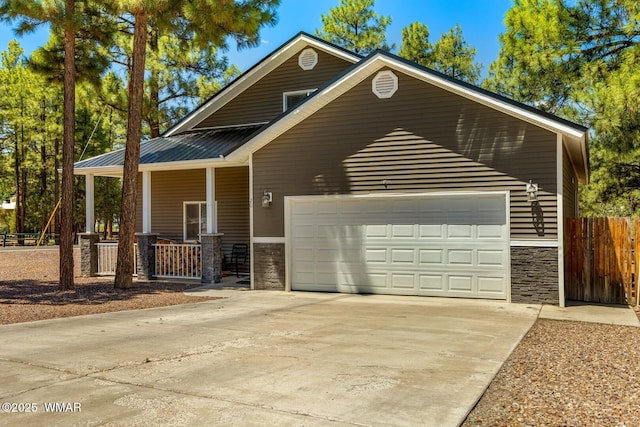 20 N Fox, Show Low, AZ 85901 - view of front of house with driveway, a porch, stone siding, and a garage