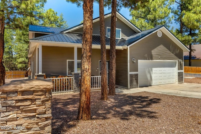 20 N Fox, Show Low, AZ 85901 - view of front of house featuring a porch, concrete driveway, an attached garage, and a metal roof
