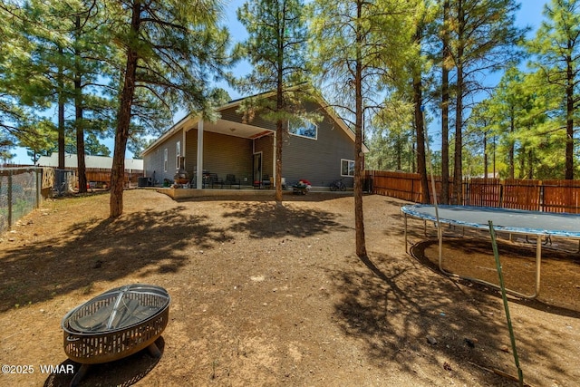 20 N Fox, Show Low, AZ 85901 - rear view of property with a trampoline and a fenced backyard