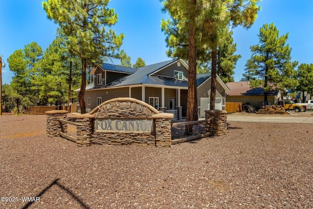 20 N Fox, Show Low, AZ 85901 - view of front of property with concrete driveway, a metal roof, and a garage