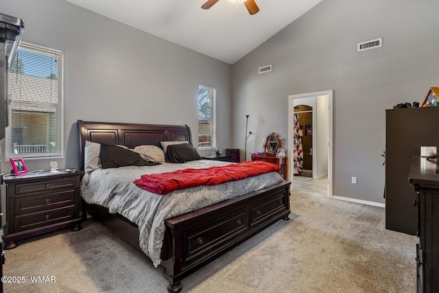 20 N Fox, Show Low, AZ 85901 - bedroom with light colored carpet, multiple windows, a walk in closet, high vaulted ceiling, and ceiling fan