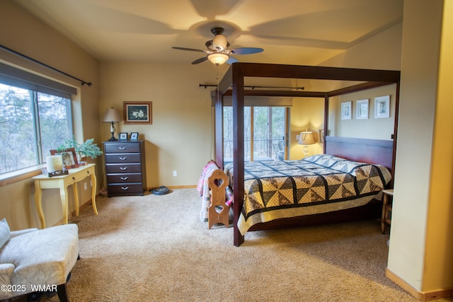 carpeted bedroom featuring multiple windows, ceiling fan, and baseboards