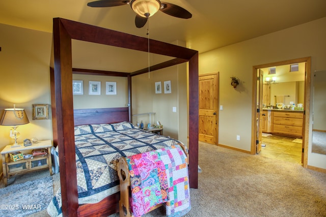 bedroom featuring carpet, ceiling fan, ensuite bath, and baseboards