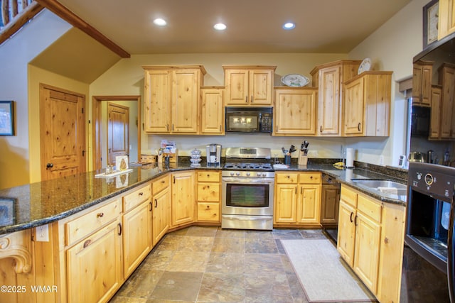 kitchen featuring black microwave, light brown cabinetry, stainless steel gas range, and dark stone counters