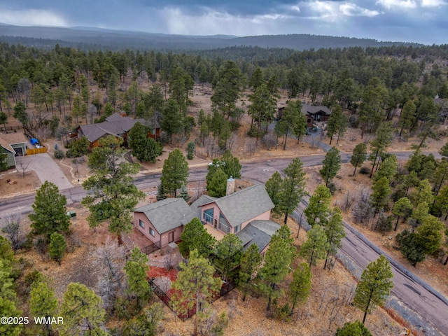 birds eye view of property with a forest view