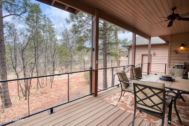 unfurnished sunroom with wood ceiling and ceiling fan