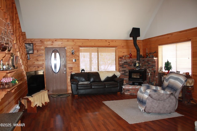 1890 Coyote Pl, Show Low, AZ 85901 - living room with a wood stove, high vaulted ceiling, wooden walls, and wood finished floors