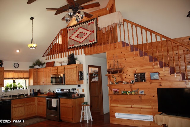 1890 Coyote Pl, Show Low, AZ 85901 - kitchen with appliances with stainless steel finishes, a high ceiling, a ceiling fan, dark wood-type flooring, and dark countertops