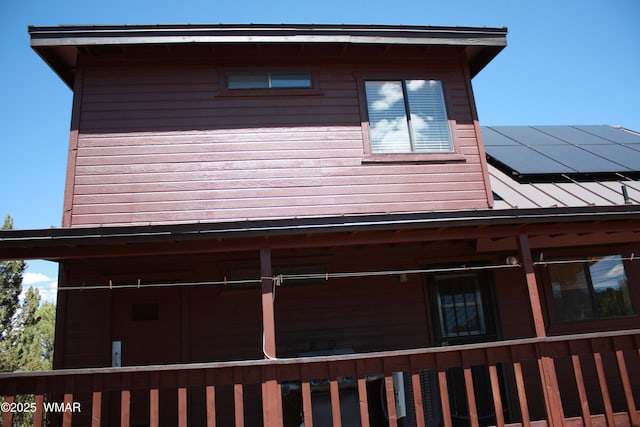 1890 Coyote Pl, Show Low, AZ 85901 - view of home's exterior featuring roof mounted solar panels and a standing seam roof