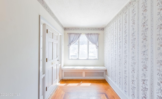 interior space with a textured ceiling and parquet floors