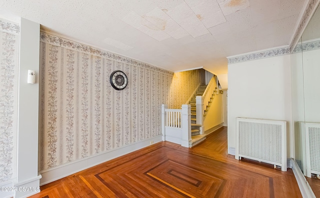 spare room with crown molding and radiator