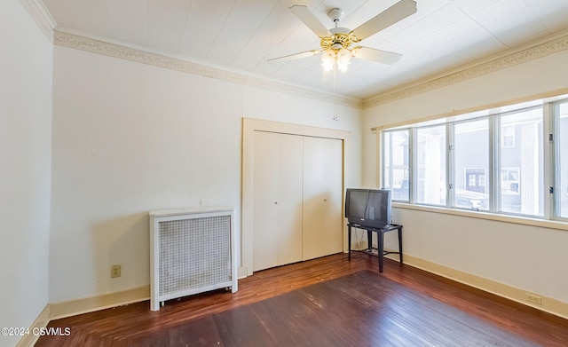 unfurnished bedroom featuring dark hardwood / wood-style flooring, a closet, ornamental molding, and ceiling fan