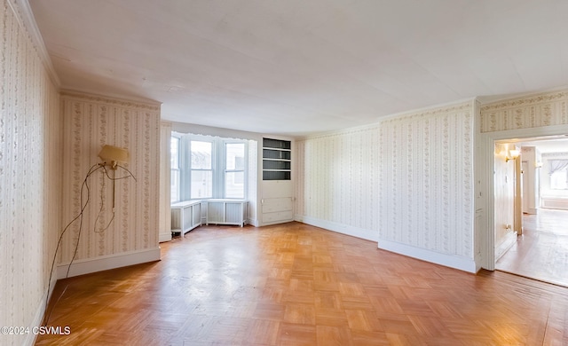 unfurnished room featuring crown molding, parquet flooring, and radiator heating unit