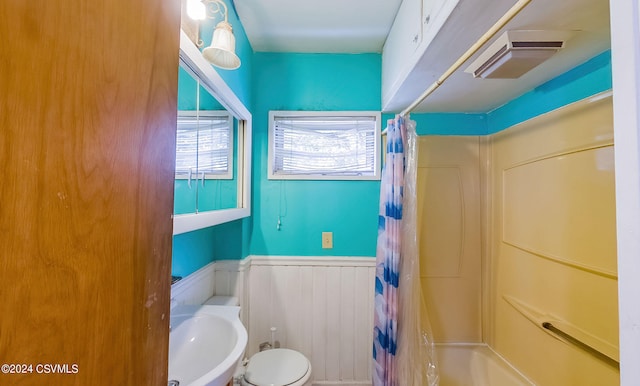 full bathroom with sink, shower / bath combination with curtain, and toilet