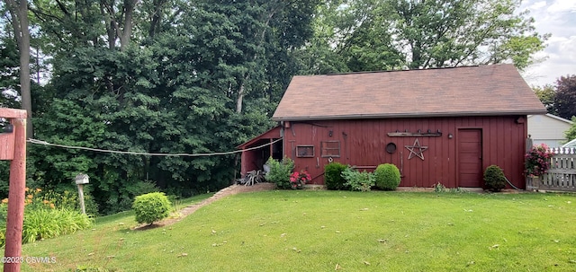 view of outdoor structure featuring a lawn