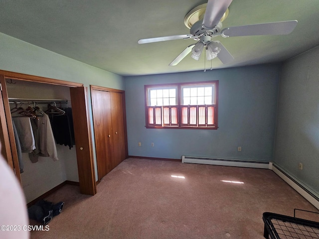 unfurnished bedroom with a baseboard radiator, ceiling fan, and dark carpet