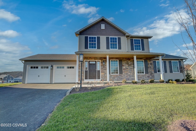 view of front facade featuring a front yard, covered porch, a garage, stone siding, and driveway