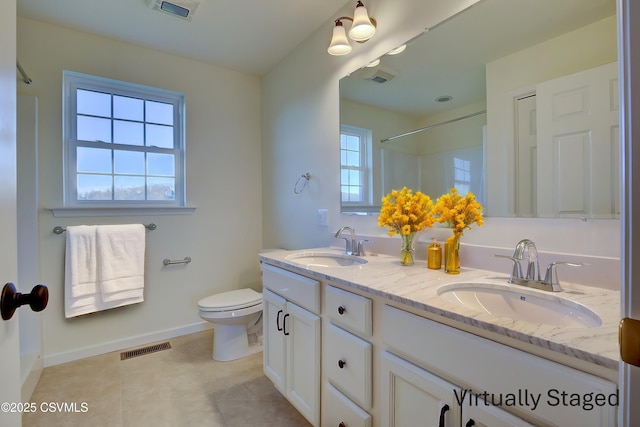 full bathroom featuring toilet, visible vents, and a sink