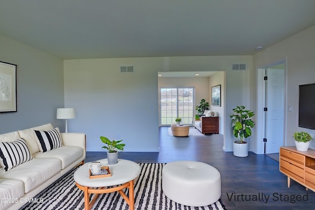 living room featuring visible vents and wood finished floors