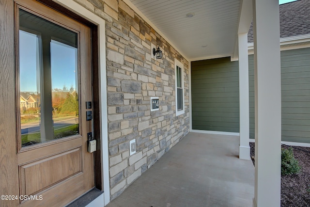 view of exterior entry with covered porch