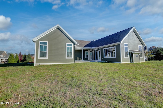 rear view of property featuring a yard