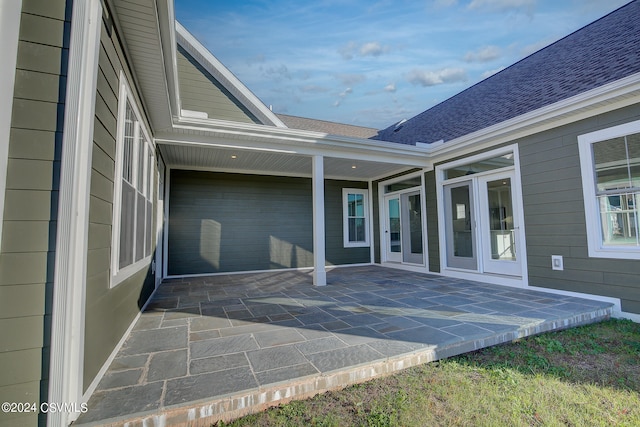 view of exterior entry featuring a patio area