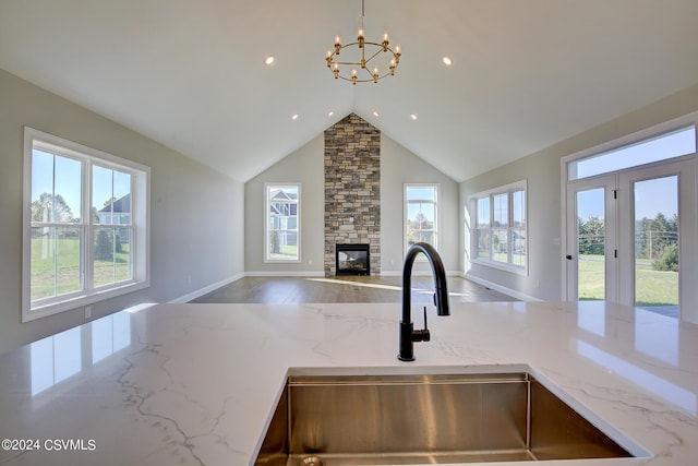 114 Windsor Way, Lewisburg, PA 17837 - kitchen featuring open floor plan, a sink, a chandelier, light stone countertops, and a fireplace