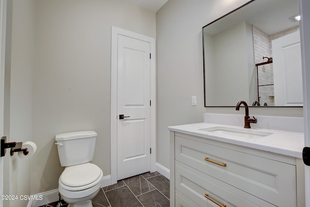 bathroom with vanity, toilet, and tile patterned flooring