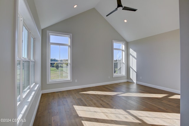 unfurnished living room featuring ceiling fan, a healthy amount of sunlight, high vaulted ceiling, and light hardwood / wood-style flooring