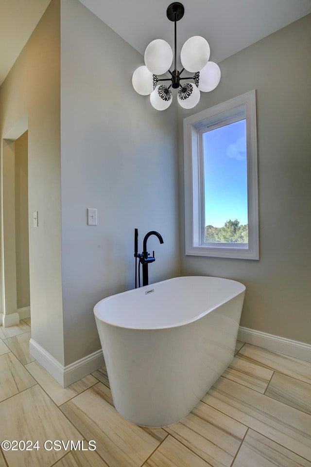 114 Windsor Way, Lewisburg, PA 17837 - bathroom with a soaking tub, a chandelier, and baseboards
