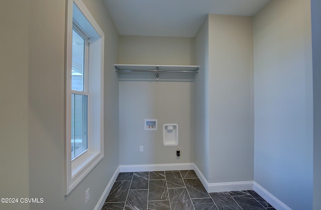 clothes washing area with hookup for a washing machine, a healthy amount of sunlight, and electric dryer hookup